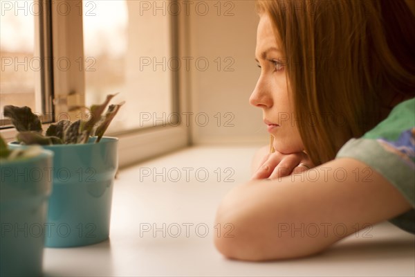 Caucasian woman looking out window