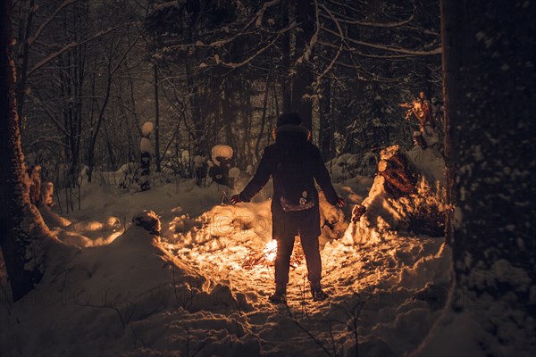 Caucasian hiker wearing headlamp exploring forest