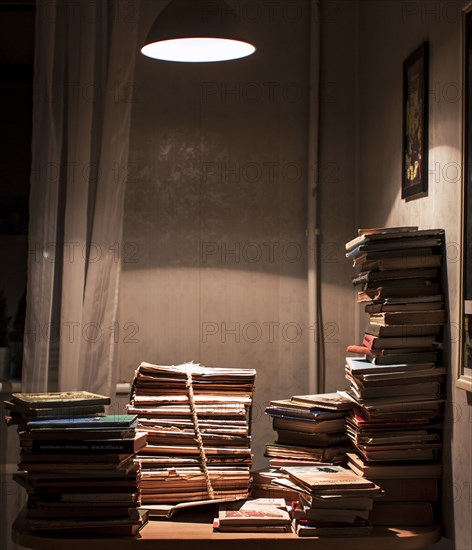 Stack of books under spotlight