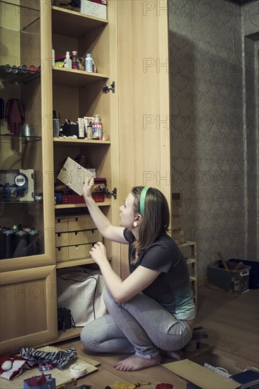 Caucasian girl replacing picture frames