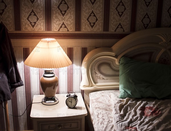 Lamp on bedside table in bedroom