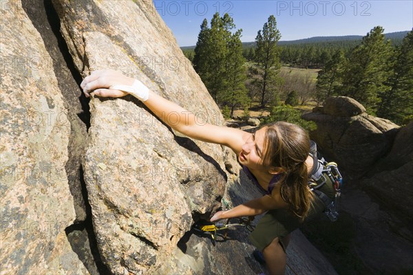 Caucasian woman rock climbing