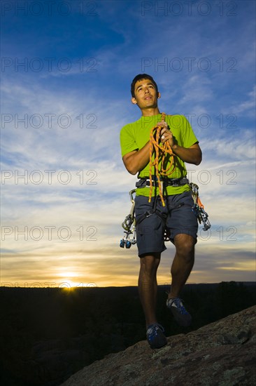 Hispanic man preparing for rock climbing