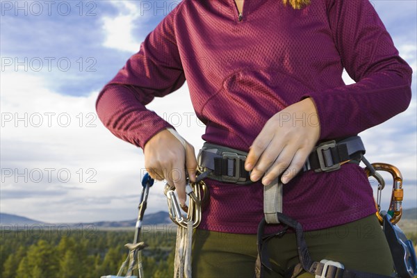 Caucasian woman preparing for rock climbing