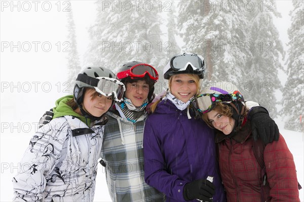 Skiers standing in snow