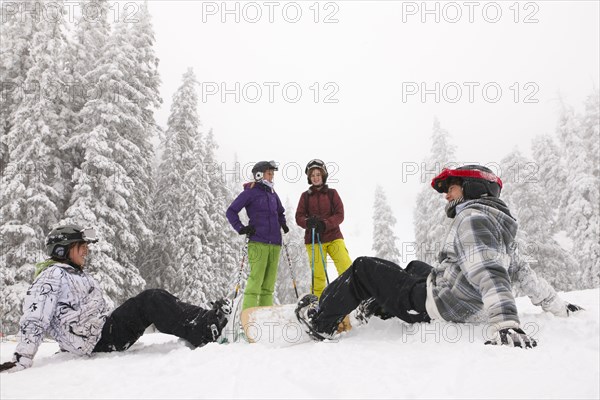 Snowboarders and skiers enjoying the snow