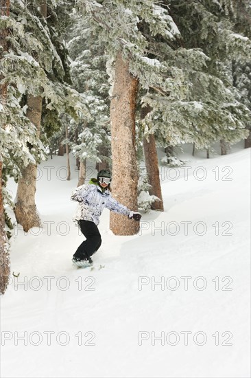 Chinese snowboarder on ski slope