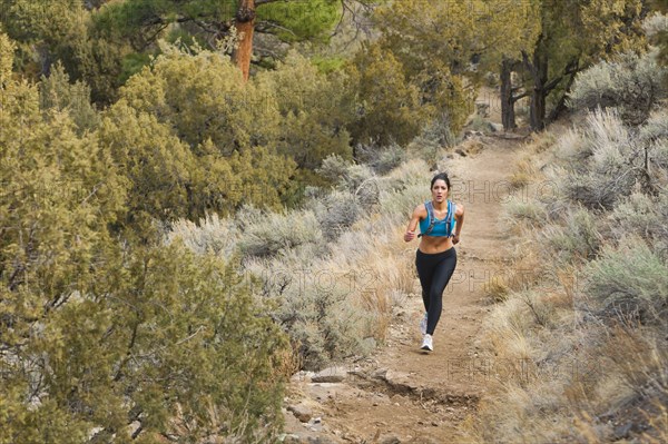 Hispanic runner training in remote area