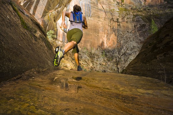 Persian woman running in a remote area