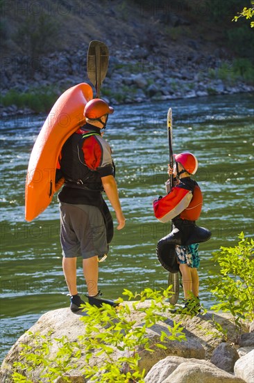 Caucasian father and child with kayak near river