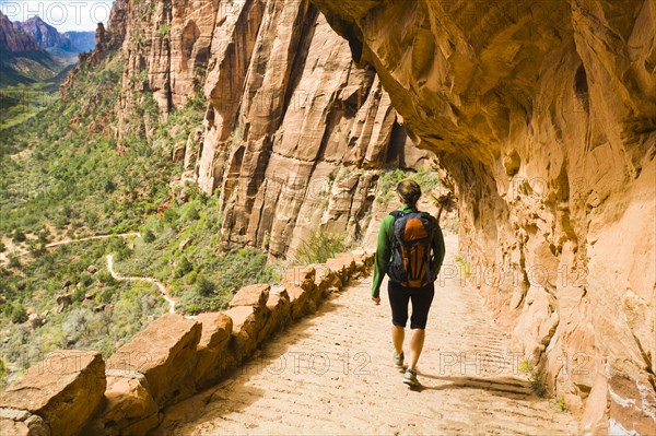 Persian woman hiking on canyon path