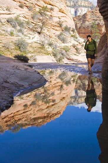 Persian woman standing near pool in canyon