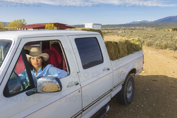 Hispanic woman driving truck