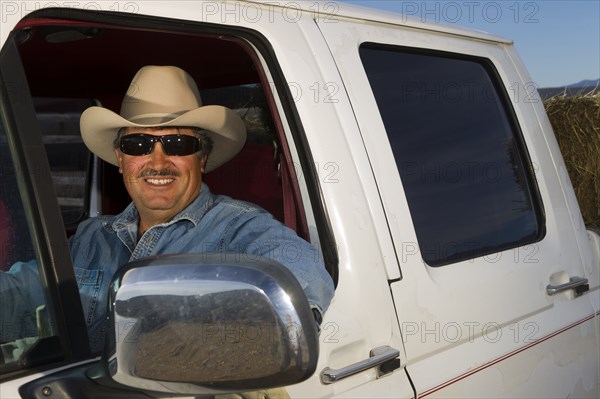 Hispanic man driving truck