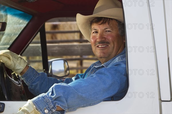 Hispanic man driving truck