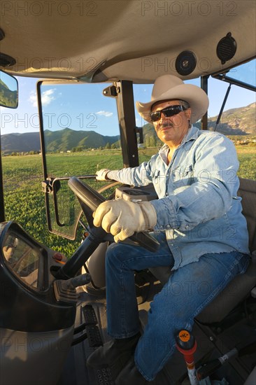 Hispanic man driving tractor