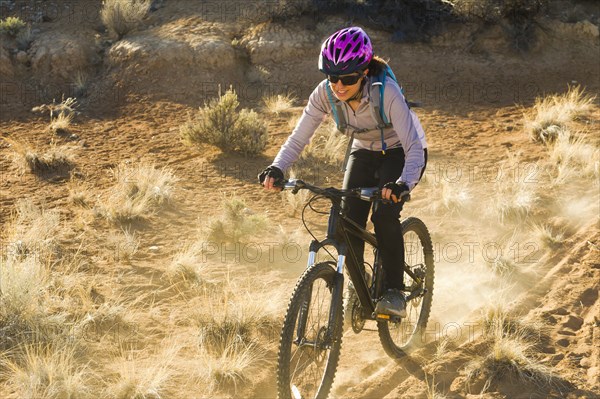 Hispanic woman mountain biking