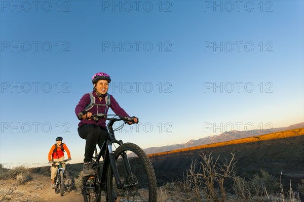 Couple mountain biking together