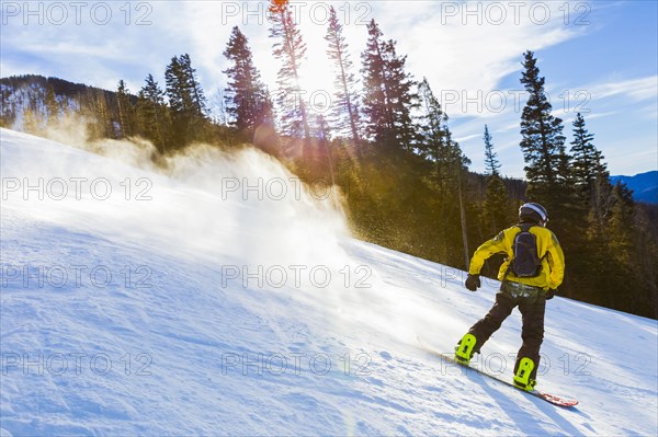 Caucasian teenager snowboarding