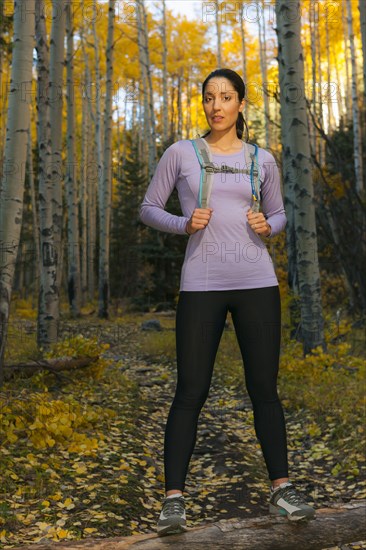 Hispanic woman hiking in woods