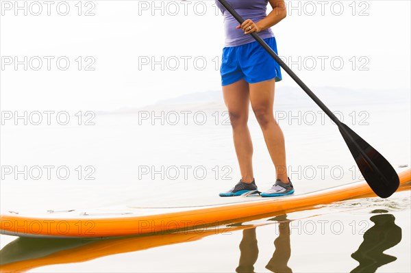 Filipino woman riding paddle board
