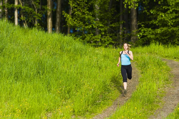 Caucasian woman running on path