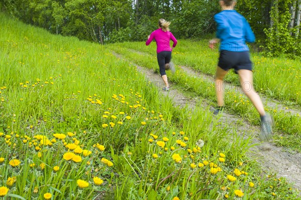 Caucasian women running on path