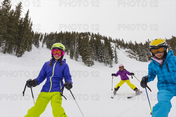 Girls skiing together on snowy slope