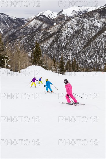Children skiing together on snowy slope