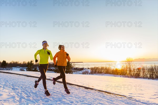 Women running on snow in winter