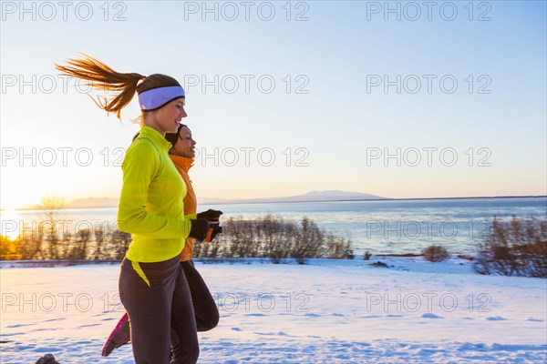 Women running on snow in winter