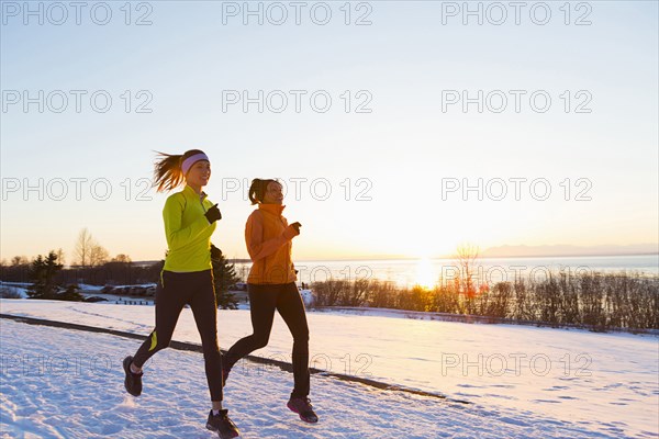 Women running on snow in winter
