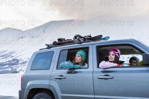Women looking from car windows in winter