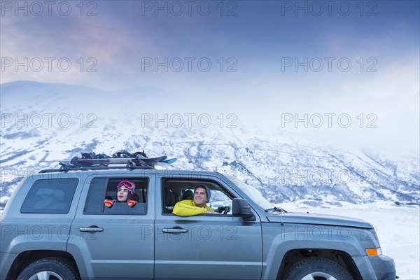 Friends looking from car window in winter