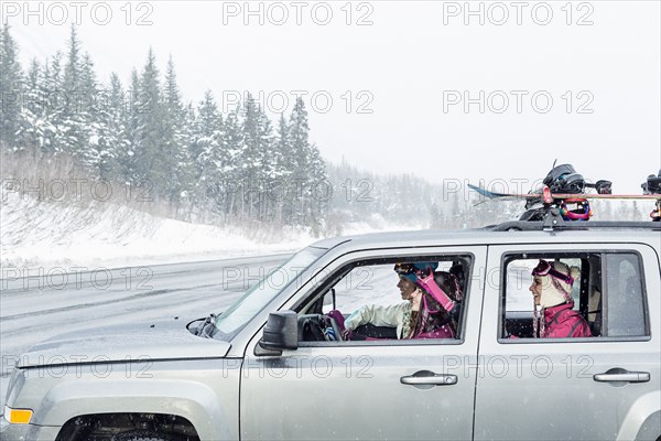 Friends driving in car in winter