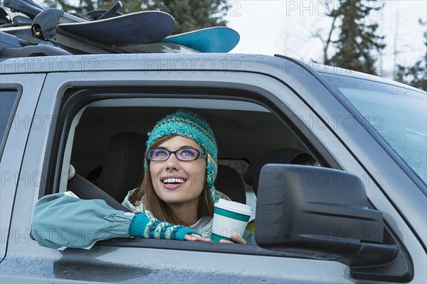 Caucasian woman  leaning in car window in winter