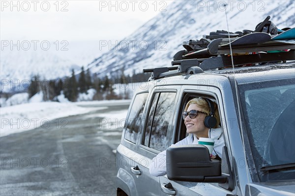 Caucasian woman  leaning in car window in winter