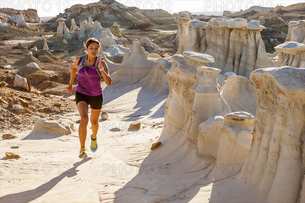 Native American woman running in desert