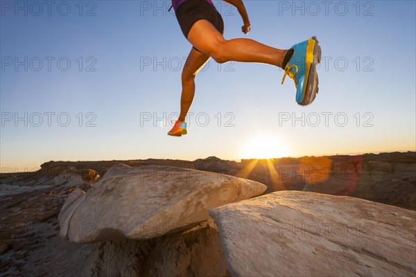 Native American woman running and jumping in desert