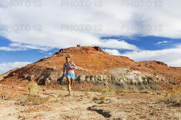 Native American woman running in desert