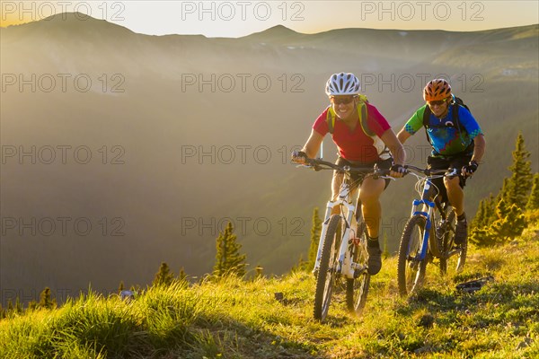 Caucasian couple mountain biking