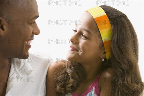 Mixed race girl smiling at father