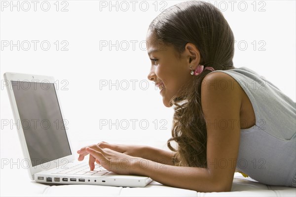 Mixed race girl using laptop