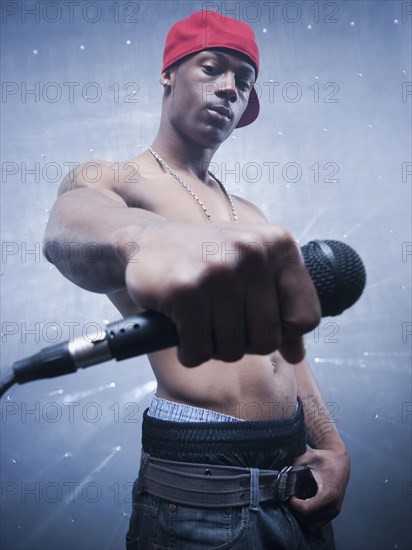Back lit African singer holding microphone