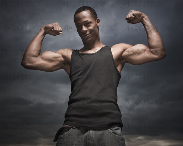 African man flexing arms