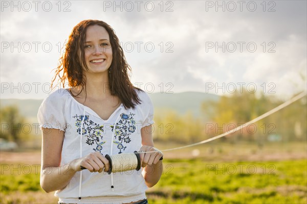 Caucasian woman flying kite