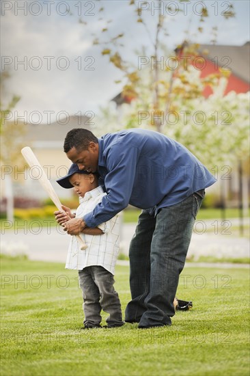 Father teaching son to play baseball