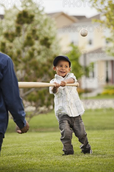 Father teaching son to play baseball