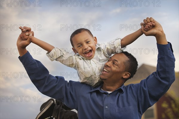 Father carrying son on back
