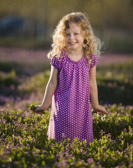 Caucasian girl picking flowers